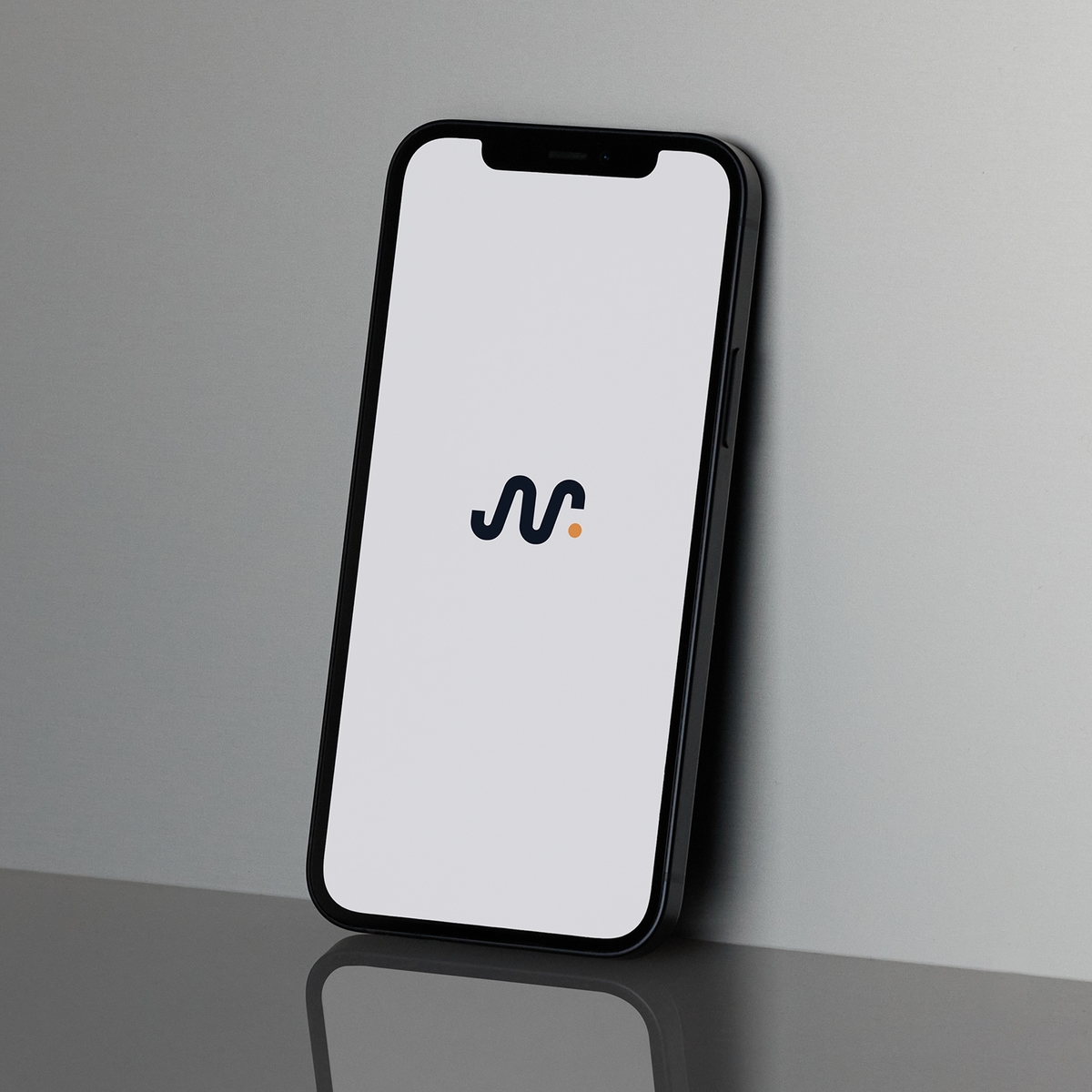 MindReady App displayed on the white screen of an iphone leant upright at an angle against a neutral wall with a glossy reflection below.